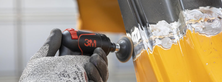 Car-body-weld-seam-being-dressed-repaired-with-roloc-disc-sander