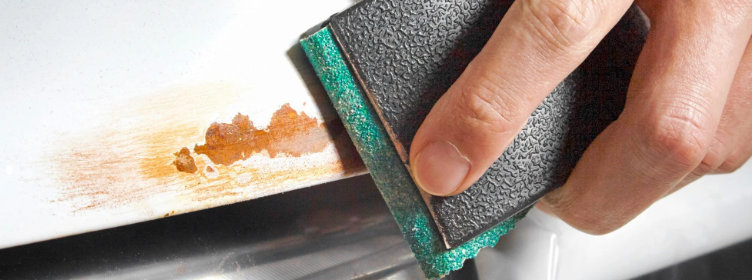 Hand-sanding-removing-rust-from-car-bodywork