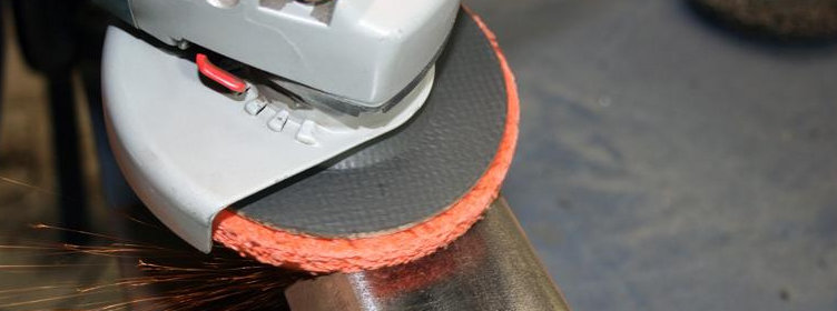 Grinding-removing-rust-from-steel-box-section-with-angle-grinder-stripping-disc