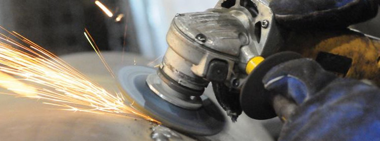 Worker-grinding-a-welded-metal-component